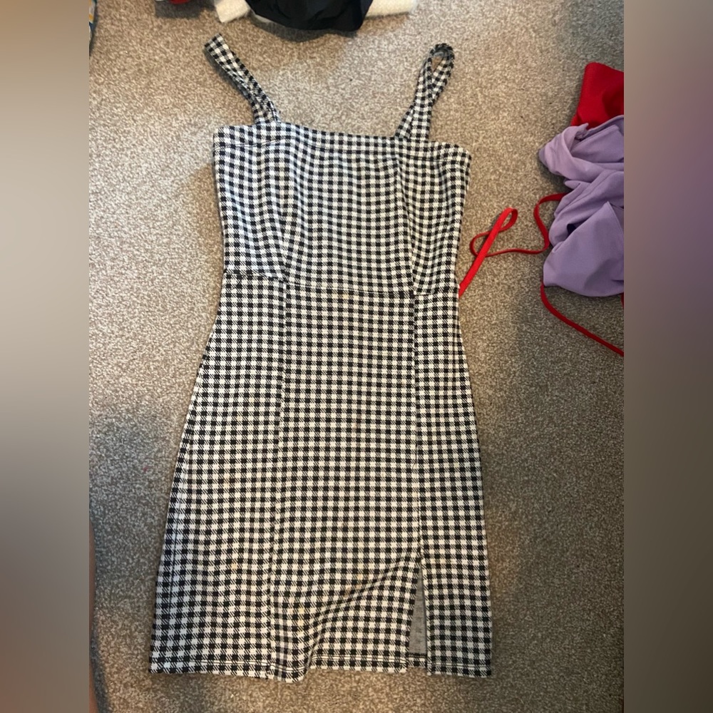 Plaid dress with small slit on leg.